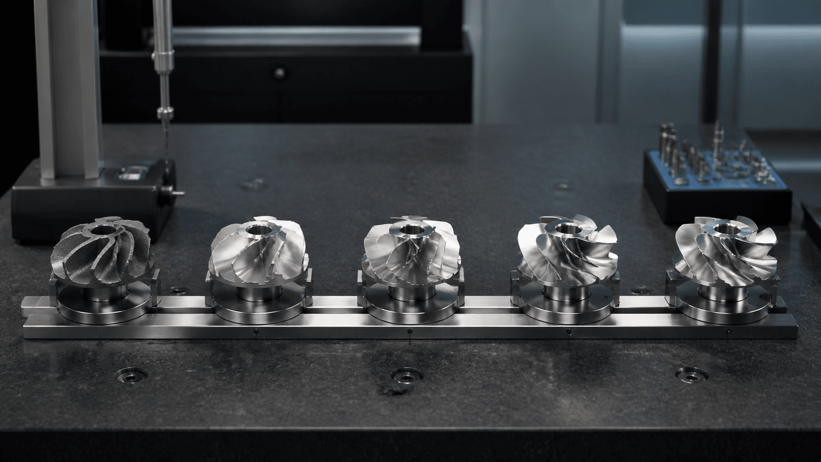 Five machined components aligned through a controlled inspection sequence